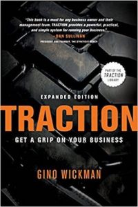 The cover of the book “Traction: Get a Grip on Your Business” by Gino Wickman. Its background is a large tire tread.