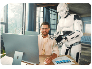 Smiling man working on a computer with a humanoid AI robot assisting him, illustrating vibe coding and AI-powered app development.